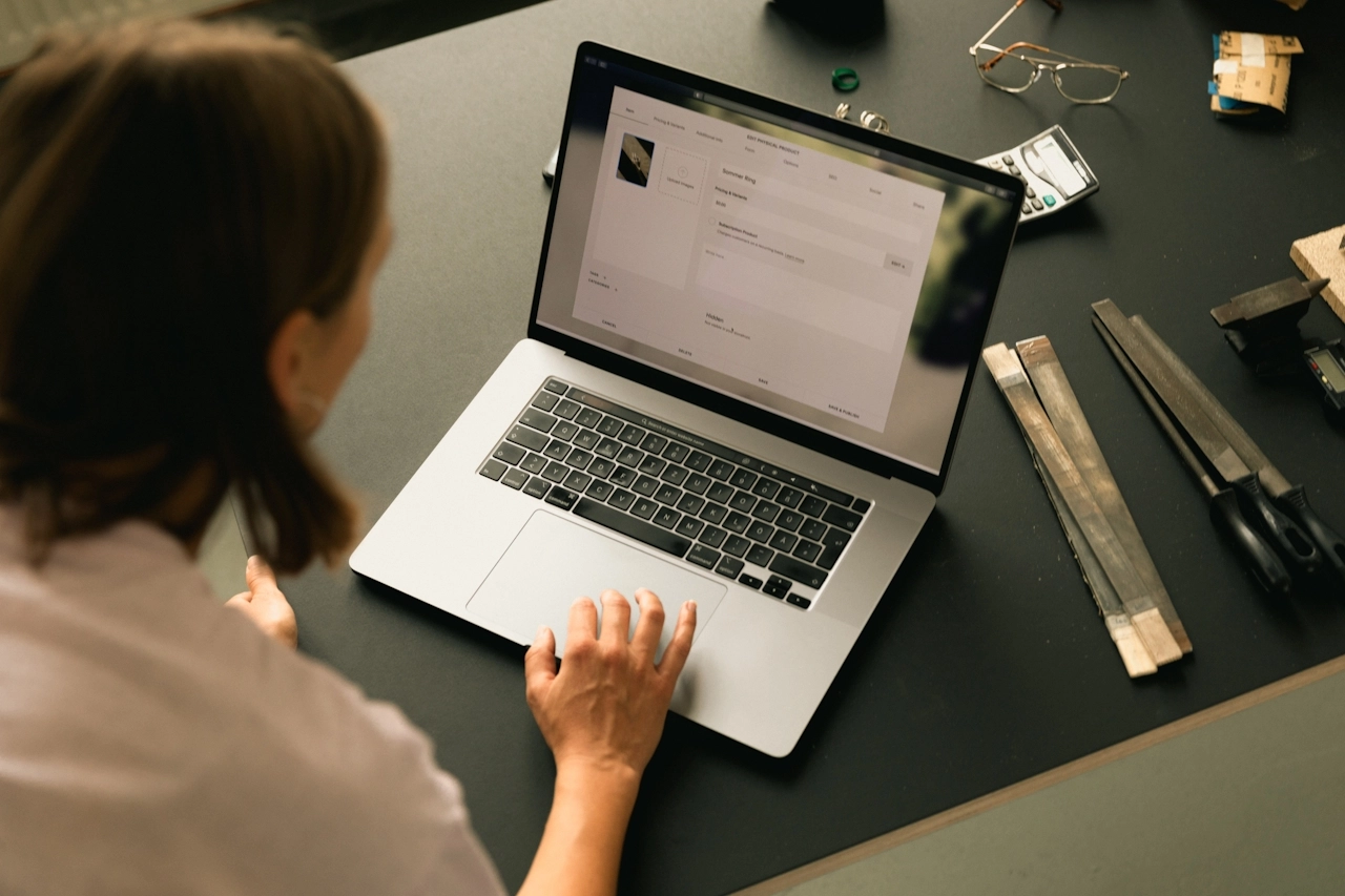 Website content and maintenance tasks being managed on a laptop